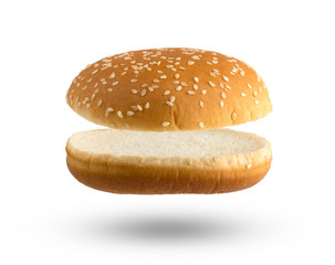 Burger bun on a white background. Two halves of a burger bun flying over a white background.