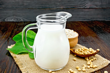Milk soy in jug with flour on dark board