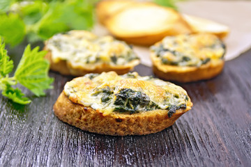 Sandwich of nettle and cheese on dark board