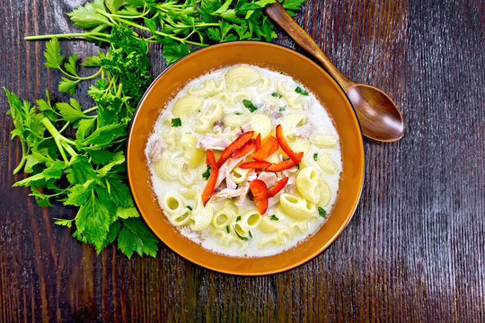 Soup creamy of chicken and pasta with pepper in plate on table top
