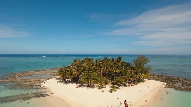 aerial footage tropical island with beach and palm trees lagoon with turquoise water Sea tropical landscape Guyam island, Philippines, Siargao. Travel concept Aerial video