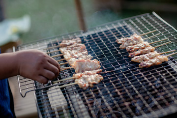 Barbecue pork Toast grill or Toast pork with Thai garnish nutrition preparation for cooking. Thai food, Street food.Pork satay grilling on stove or Thai style roasted pork at the market.