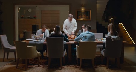 Senior man grandfather cutting turkey for family on thanksgiving dinner. 4K UHD 60 FPS SLOW MOTION Blackmagic RAW