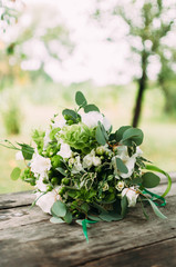 The bouquet of white flowers on the wooden background.