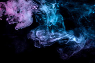 Clouds of isolated colored smoke: blue, red, green, pink; scrolling on a black background in the dark close up.