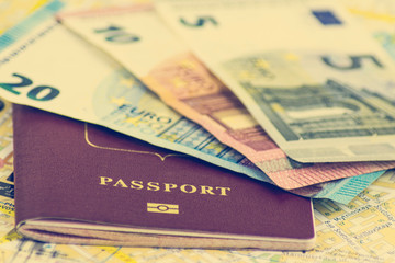 The concept of journey, passport, cash money 5, 10, 20 euro on the background of the map