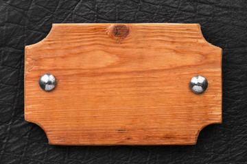Frame made of wood board, fastened with iron rivets to black leather.