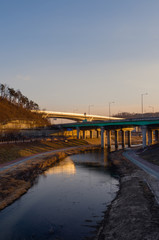 Fototapeta premium Highway on river at late afternoon sunset