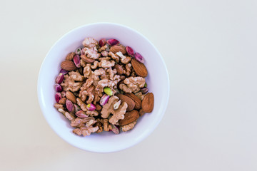 Different types of nuts- assorted walnuts, almonds and pistachios. Concept- healthy diet,  full source of vegetable protein in vegetarianism and raw food.