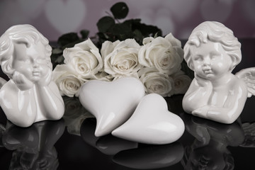 A bouquet of white roses, angels of love and porcelain hearts, Valentine's Day