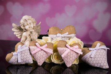 A bouquet of white roses, hearts made of material, angels. Valentines