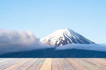 Mountain fuji at morning in Japan and empty wood desk .Blank space for text and images.