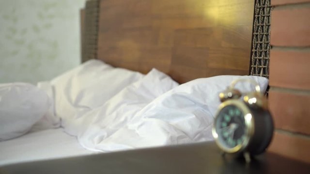 Alarmed Woman Looks At The Time And Gets Out Of Bed Quickly.
