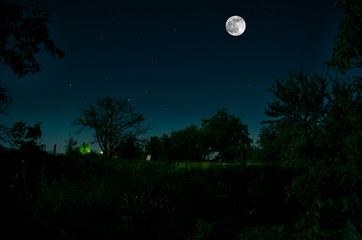 Full moon over the ruins of old grunge building at night. Beautiful night landscape with full moon. Azerbaijan