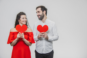 Beautiful attractive, cheerful, positive pair. Are married Hold large red cards in their sleeves. When they look at each other.