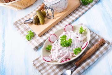 delicious homemade meat salad with mayonnaise and cucumber