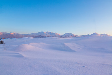Snow dunes with palandoken mountains background in Erzurum, Turkey