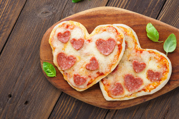 Heart shaped mini pizza. Valentine's day romantic menu.