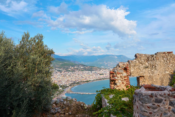 Naklejka premium A part of medieval wall, mountains and sea shore of Alanya, Turkey. Natural background.