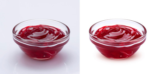Bowl of red berry jam isolated on white background