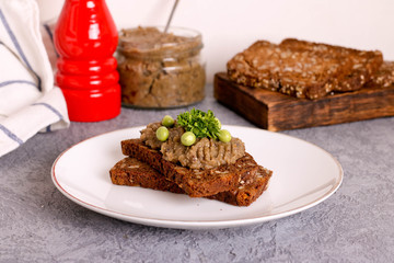 Fototapeta na wymiar Fresh homemade chicken liver pate on bread on a white plate