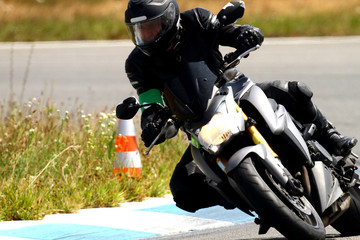 A biker in combination to cook on a motorcycle in a bend on a circuit