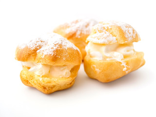 Tree cream puffs on white background