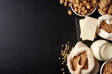 Soy products on black background, from above
