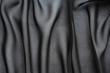 black chiffon fabric with large folds, textile background