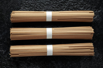 Noodles soba, buckwheat on black background. Traditional Japanese food.