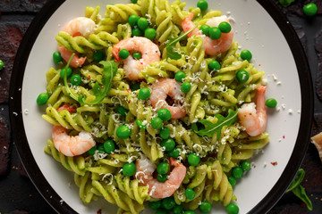 Italian pasta in a creamy pesto sauce with shrimp, prawns
