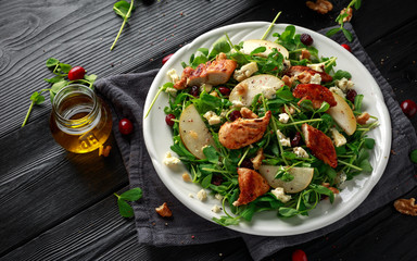 Pear, chicken salad with blue cheese, cranberry and walnuts. concept healthy food. black background