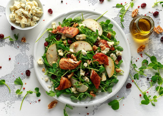 Pear, chicken salad with blue cheese, cranberry and walnuts. concept healthy food