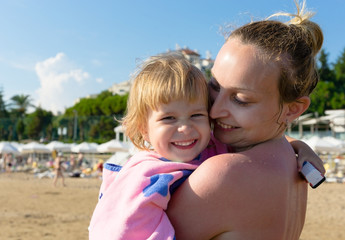 Mom with her daughter on the beach