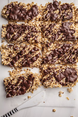 Homemade chocolate oat bars on a white background, top view. Healthy vegan dessert, detox food.