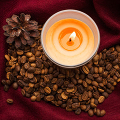 Background from grains of coffee and candles with a cone