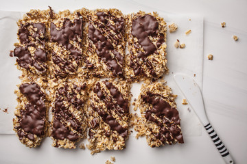 Homemade chocolate oatmeal bars on a white background, top view. Healthy vegan dessert, detox food.