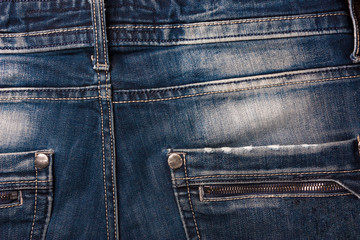 Fototapeta premium Denim background, seams on denim, pockets, stylish clothing design.