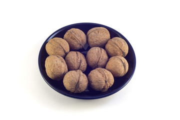  Nuts in a black plate on a white background