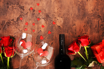 Composition for Valentine's Day.  Roses, gift, glasses and wine, red hearts. Top view. 