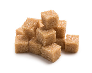 Heap of cane sugar cubes isolated on white background