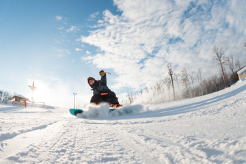 fearless snowboarder is riding fast. full length photo. photo in action. dangerous stop. man...
