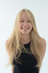 Fototapeta premium girl in black swimsuit with white hair smiling and showing emotions in the Studio