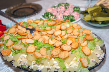 Chicken salad with pineapples and crackers on the table. Festive dish.