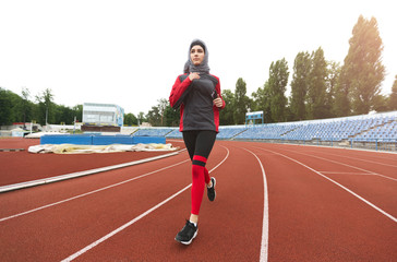 Fototapeta premium Arabian girl running on stadium