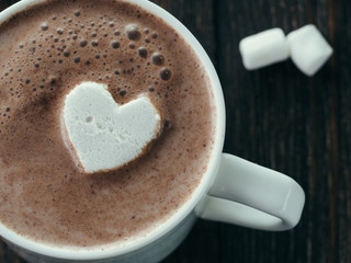 Hot chocolate with marsmallow in heart shape. Close up view of cup with hot cocoa or chocolate. St....