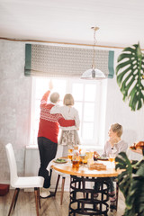 grandparent and a little girl are waiting for guests at home.