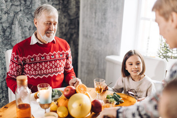 old man is happy as he gathered all his sons and daughters together. togetheness