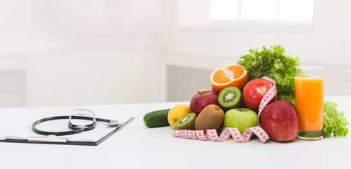 Nutritionist desk with healthy fruit and stethoscope
