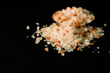 Himalayan salt close up, metal bowl, black background, free copy space